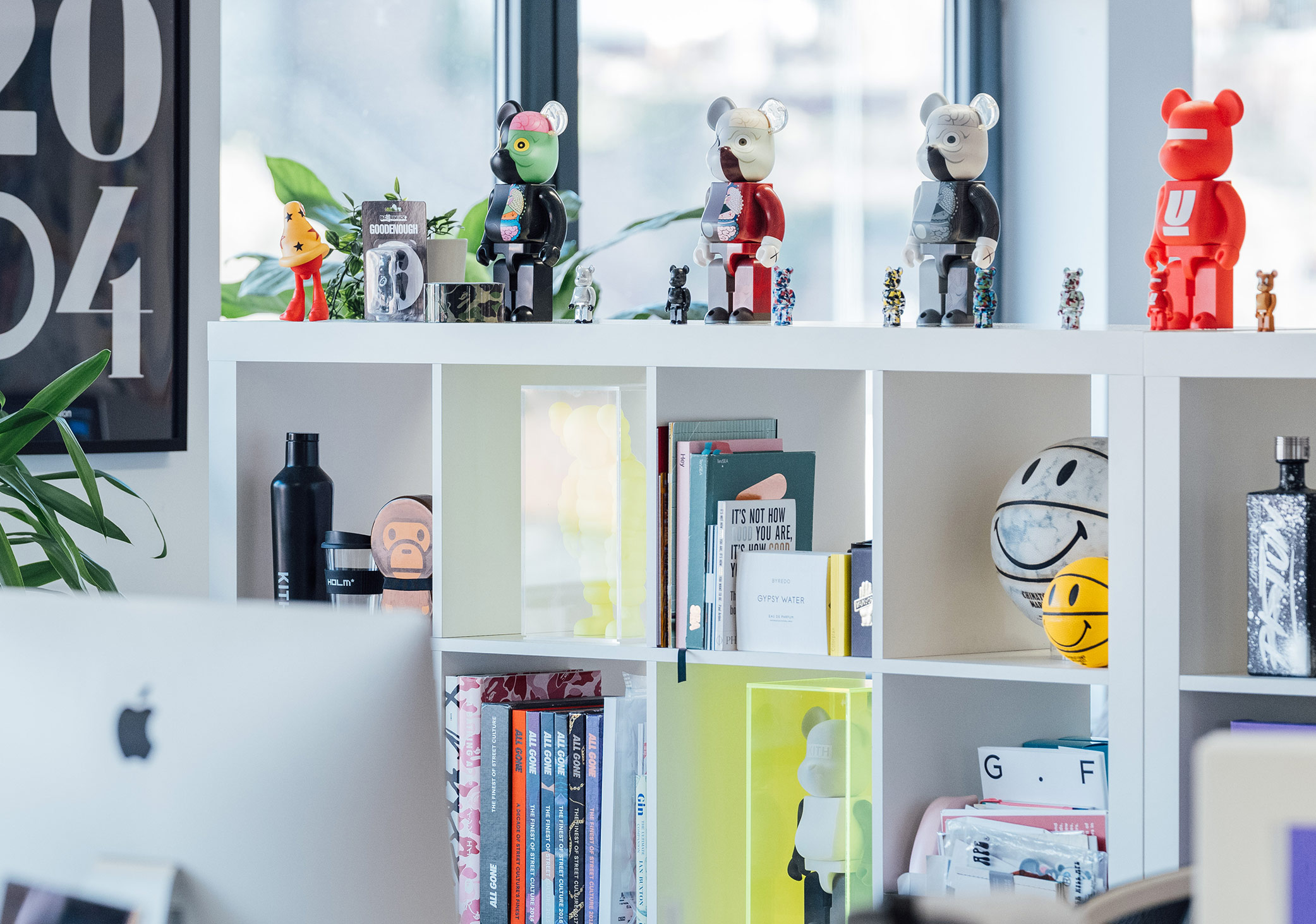 DesignReligion studio photo showing white shelving with a collection of design products and literature