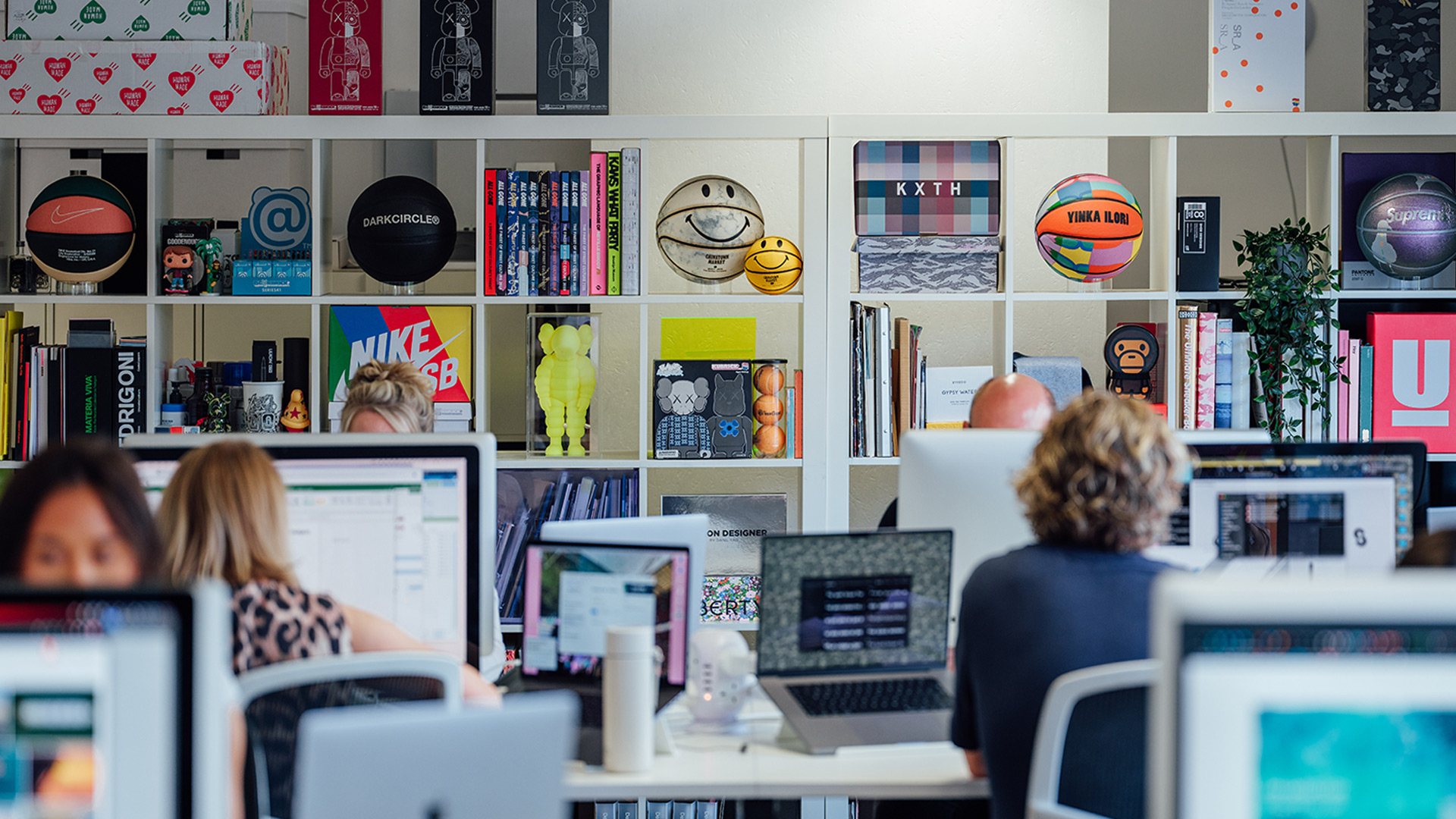 DesignReligion office showing interior decoration with shelving units displaying products and art